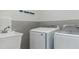 Modern laundry room featuring a new washer, dryer, and utility sink at 3258 Bransley Way, Duluth, GA 30097