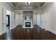 Spacious living room features a marble fireplace, dark wood floors, and arched doorways at 3258 Bransley Way, Duluth, GA 30097