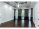 Spacious living room featuring a decorative tray ceiling, hardwood floors, and abundant natural light at 3258 Bransley Way, Duluth, GA 30097