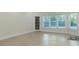 Bright living area with herringbone floors, large windows, and access to the backyard at 3258 Bransley Way, Duluth, GA 30097