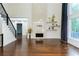 Open-concept living room with fireplace, hardwood floors, and lots of natural light at 3258 Bransley Way, Duluth, GA 30097