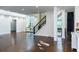 Large living room featuring hardwood floors, an elegant staircase, and access to other parts of the house at 3258 Bransley Way, Duluth, GA 30097