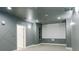 Media room with gray walls, projector screen, and sconce lighting at 3258 Bransley Way, Duluth, GA 30097