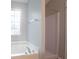 A well-lit bathroom featuring a bathtub and a separate shower with a window at 3617 Summit Trce, Decatur, GA 30034