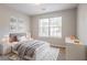Cozy bedroom with a gray bed, dresser, and a window allowing natural light at 3617 Summit Trce, Decatur, GA 30034