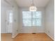 Bright dining area features hardwood floors, a large window, and a stylish light fixture at 3617 Summit Trce, Decatur, GA 30034