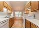 Galley kitchen features white appliances, oak cabinets, and laminate countertops at 3617 Summit Trce, Decatur, GA 30034
