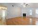 Spacious living room with a fireplace, hardwood floors, vaulted ceiling, and a ceiling fan at 3617 Summit Trce, Decatur, GA 30034