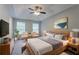 Main bedroom featuring a ceiling fan, a bed and dressers, with natural light from the windows at 3617 Summit Trce, Decatur, GA 30034