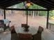 Relax on this covered back porch with a round table, chairs, and grill perfect for outdoor dining at 4678 Browns Mill Ferry Rd, Lithonia, GA 30038