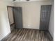 Empty bedroom with modern laminate flooring and neutral paint, ready for personalization at 4678 Browns Mill Ferry Rd, Lithonia, GA 30038