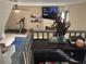 Upstairs bonus room with a fireplace, TV, ceiling fan, and exercise equipment for a versatile space at 4678 Browns Mill Ferry Rd, Lithonia, GA 30038