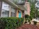 Two-story home with tan siding, a bright blue front door, and well-manicured landscaping in the front at 4678 Browns Mill Ferry Rd, Lithonia, GA 30038