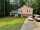 Inviting two-story home with tidy landscaping, charming shutters, and a paved driveway leading to an attached garage at 4678 Browns Mill Ferry Rd, Lithonia, GA 30038