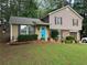 Charming two-story home with a well-maintained lawn, tidy landscaping, and a bright blue front door at 4678 Browns Mill Ferry Rd, Lithonia, GA 30038
