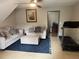 Cozy living room with comfortable sofas, a blue rug, and tiled floors, creating a welcoming atmosphere at 4678 Browns Mill Ferry Rd, Lithonia, GA 30038
