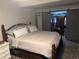 Spacious main bedroom with a large bed, closet featuring sliding doors, and unique flooring at 4678 Browns Mill Ferry Rd, Lithonia, GA 30038