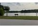 Enjoy community living with access to a pond and park benches, as seen in this neighborhood view at 4678 Browns Mill Ferry Rd, Lithonia, GA 30038
