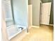 Bright bathroom boasts a tub-shower combination, offering a clean and functional space for relaxation at 10175 Hemlock Way, Jonesboro, GA 30238