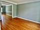 Open-concept living room offers hardwood floors and seamless transition into the dining area, for entertaining at 10175 Hemlock Way, Jonesboro, GA 30238