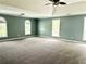 Spacious main bedroom features neutral carpeting, a ceiling fan, and abundant natural light from the many windows at 10175 Hemlock Way, Jonesboro, GA 30238