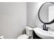 Contemporary bathroom showcasing a stylish vanity with modern fixtures and a round mirror at 212 Teepee Trl, Whitesburg, GA 30185