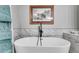 Elegant bathroom showcasing a freestanding tub, sleek fixtures, and elegant marble tiling at 212 Teepee Trl, Whitesburg, GA 30185