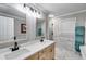 Bright bathroom with double vanity, quartz countertop, modern fixtures and a view of the walk in shower at 212 Teepee Trl, Whitesburg, GA 30185