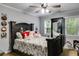 A comfy bedroom featuring wood floors, light gray walls, and a ceiling fan at 212 Teepee Trl, Whitesburg, GA 30185