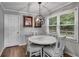Small dining room with round table and hardwood floors at 212 Teepee Trl, Whitesburg, GA 30185