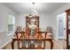 Traditional dining room with modern chandelier and hardwood floors at 212 Teepee Trl, Whitesburg, GA 30185