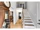 Bright foyer with wood floors and staircase at 212 Teepee Trl, Whitesburg, GA 30185