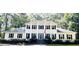 Traditional two-story home with black shutters and American flag on large front porch with pillars at 212 Teepee Trl, Whitesburg, GA 30185