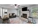 Cozy living room featuring a fireplace, tv, and neutral paint at 212 Teepee Trl, Whitesburg, GA 30185
