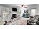 Bright living room featuring a fireplace, tv, and colorful area rug at 212 Teepee Trl, Whitesburg, GA 30185