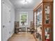 Cozy room with display cabinet, two wooden chairs and window view to the yard at 212 Teepee Trl, Whitesburg, GA 30185