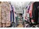 Organized walk-in closet featuring ample storage, shelving, and a decorative chandelier at 212 Teepee Trl, Whitesburg, GA 30185