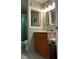 Bathroom with light wood vanity, patterned floor, and tub shower with green shower curtain at 3317 Shady Oak Dr, Atlanta, GA 30340