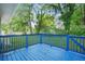 Blue wooden deck overlooks a lush green lawn with views of mature trees and neighborhood at 390 Lincoln Sw Pl, Atlanta, GA 30315