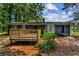 Spacious backyard featuring a wooden deck, brick patio, and mature trees at 4756 Fellsridge Dr, Stone Mountain, GA 30083