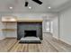 Living room featuring a decorative stone fireplace, open shelving, and hardwood floors at 4756 Fellsridge Dr, Stone Mountain, GA 30083