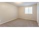 Neutral bedroom features plush gray carpeting and a window providing natural light at 5092 Stone Trce, Stone Mountain, GA 30083