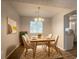 Well-lit dining room showcases stylish chandelier, decor, and sleek hardwood floors at 5092 Stone Trce, Stone Mountain, GA 30083