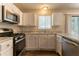 Bright kitchen featuring stainless steel appliances, ample countertop space, and modern cabinetry at 5092 Stone Trce, Stone Mountain, GA 30083