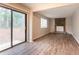 Spacious living room with sliding glass doors, a stone fireplace, and modern luxury vinyl plank flooring at 5092 Stone Trce, Stone Mountain, GA 30083