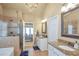 Spacious bathroom with dual vanities, granite counters, tile floors, shower, and tub, providing a luxurious feel at 5310 Chestnut Dr, Cumming, GA 30040