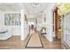 Open-concept entryway with hardwood floors, white wainscoting and decorative accents at 5310 Chestnut Dr, Cumming, GA 30040