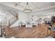 Open-concept living room with a fireplace, hardwood floors, and an elegant chandelier at 5310 Chestnut Dr, Cumming, GA 30040