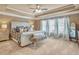 Spacious main bedroom with tray ceiling, carpet, and large windows for natural light and backyard view at 5310 Chestnut Dr, Cumming, GA 30040