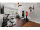 Bright exercise room with hardwood floors, treadmill, weights, and punching bag at 103 Brightmoor Ct, Canton, GA 30115